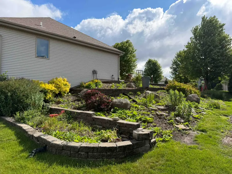 Stone-edged garden bed before