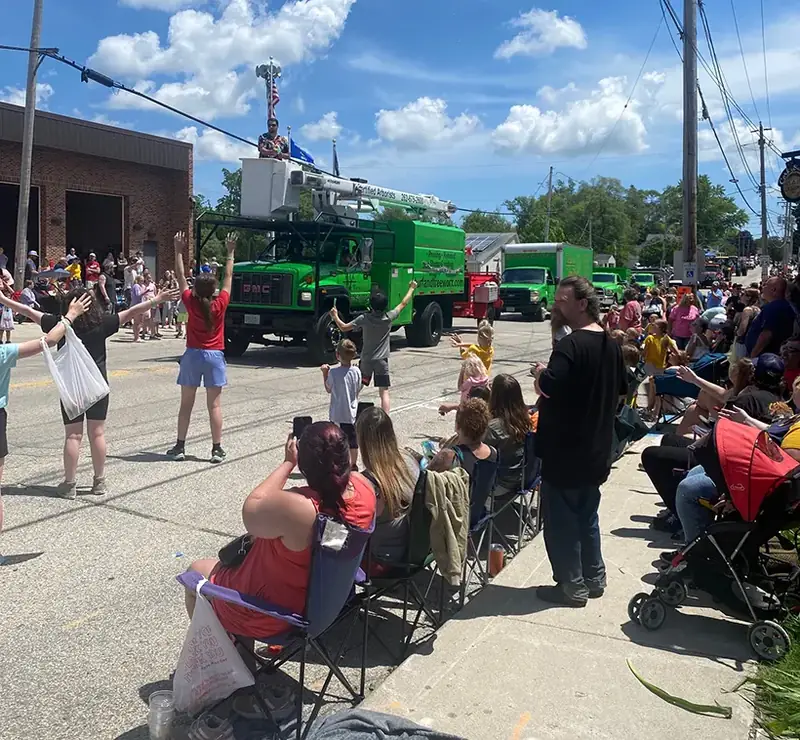 Crowds watching the Turf & Tree Worx trucks at the Newburg Parade